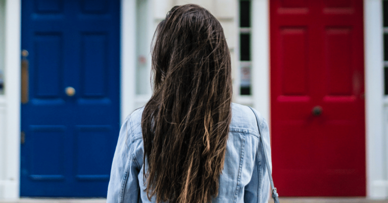 woman trying to choose a red door or blue door